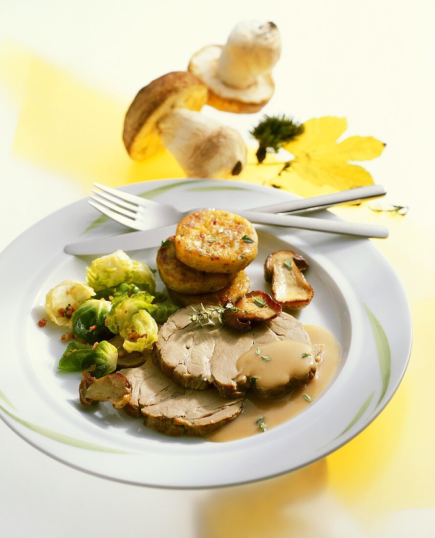 Roast wild boar with ceps and Brussels sprouts