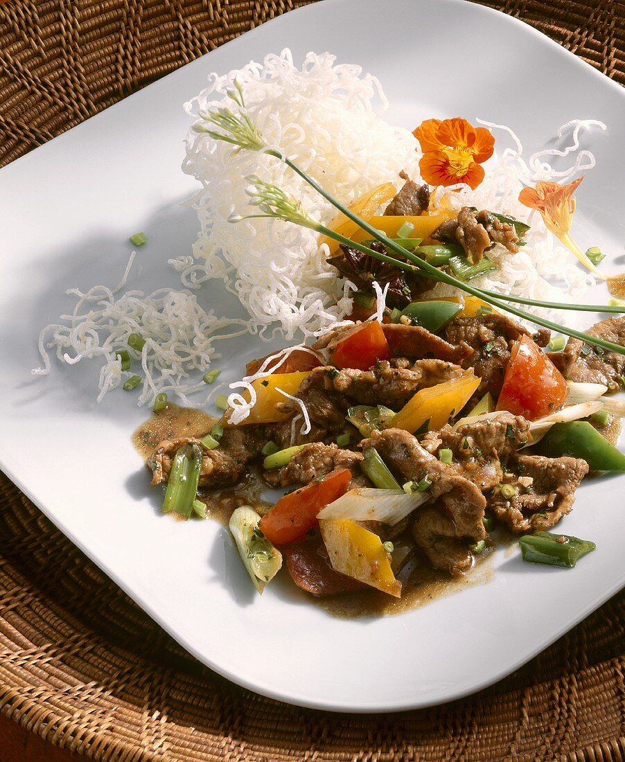 Strips of wild boar with vegetables and rice noodles