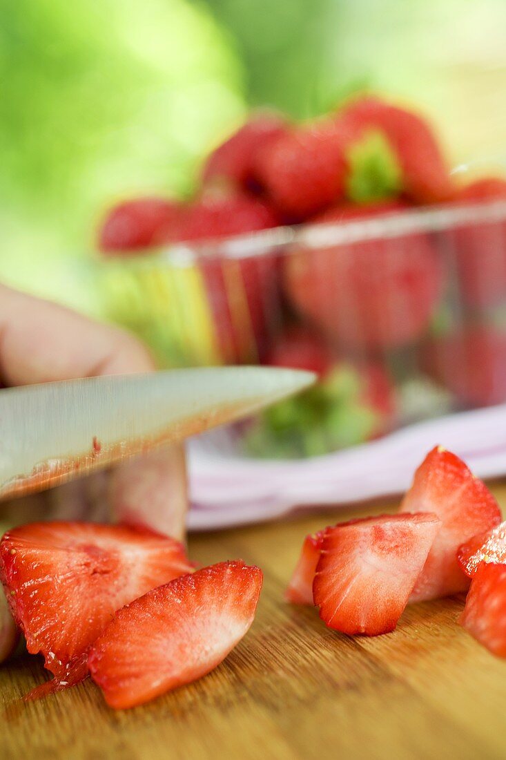 Cutting strawberries into pieces