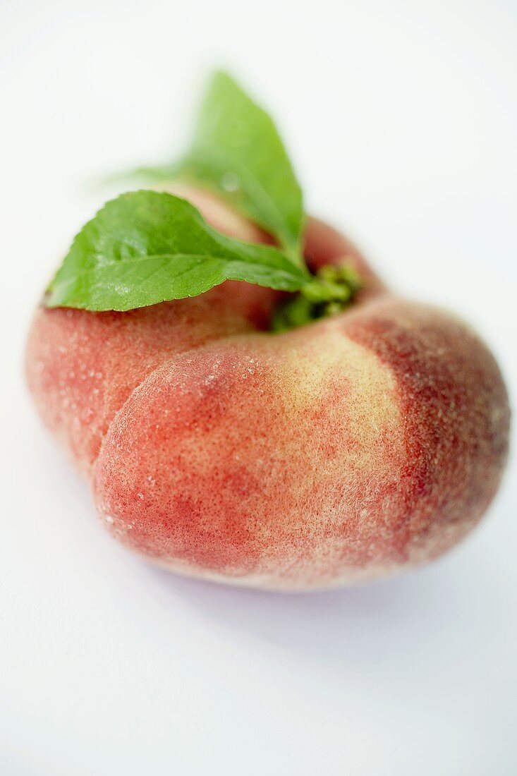 A peach with leaves