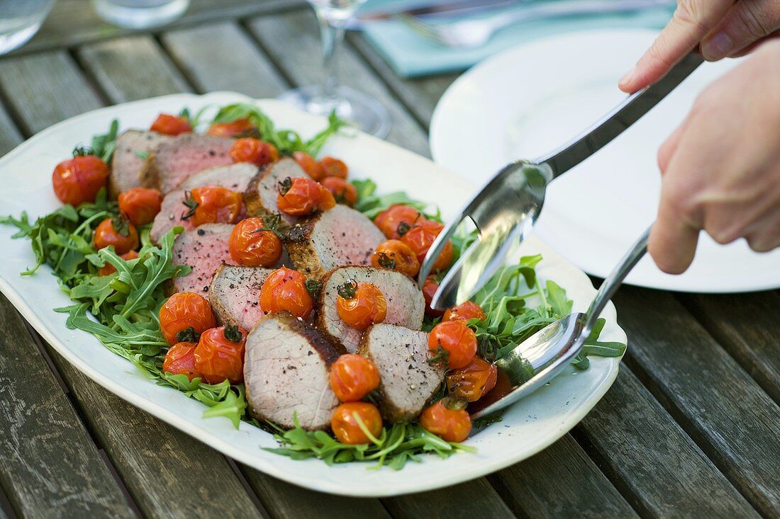 Roast beef with roasted tomatoes and rocket