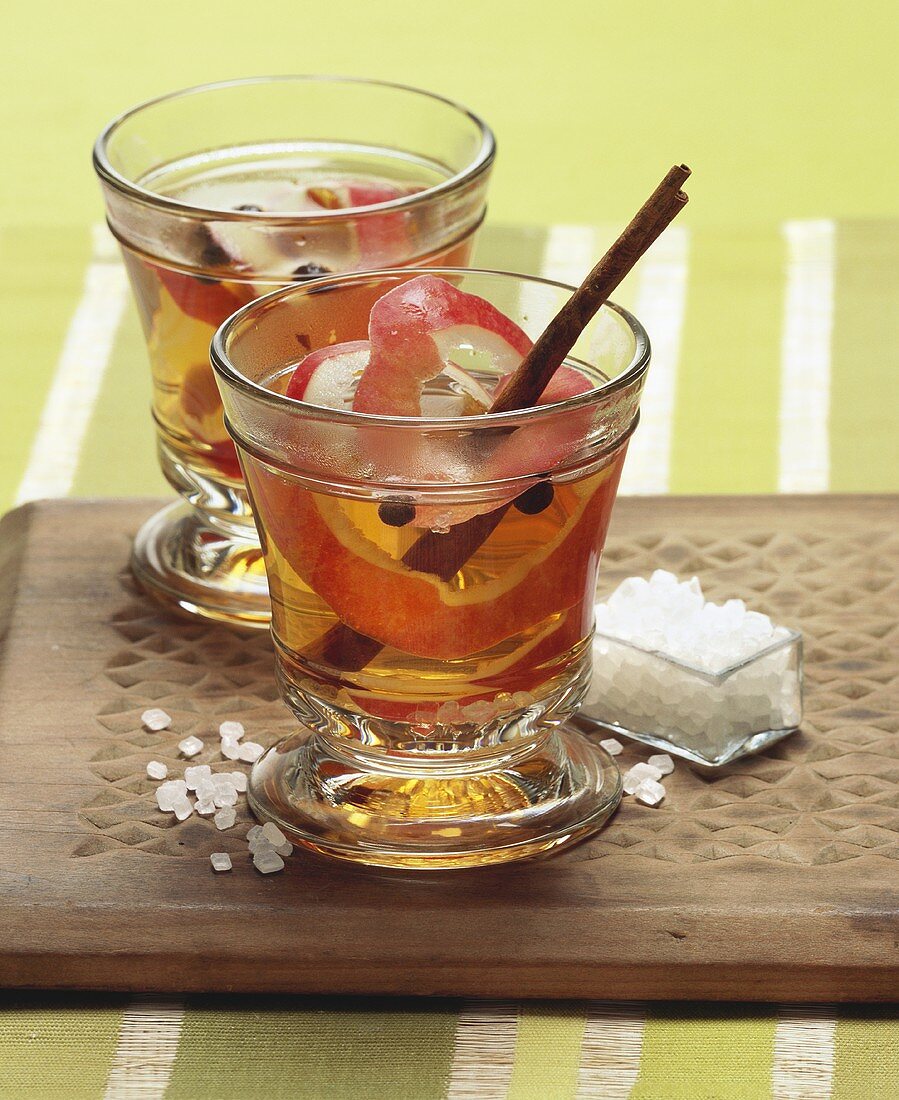 Apple punch with cinnamon stick and pearl sugar