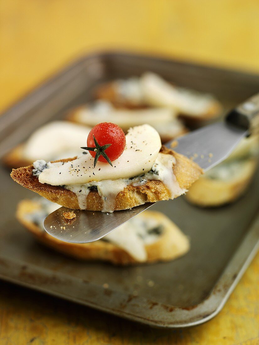 Cheese, pear and tomato crostini