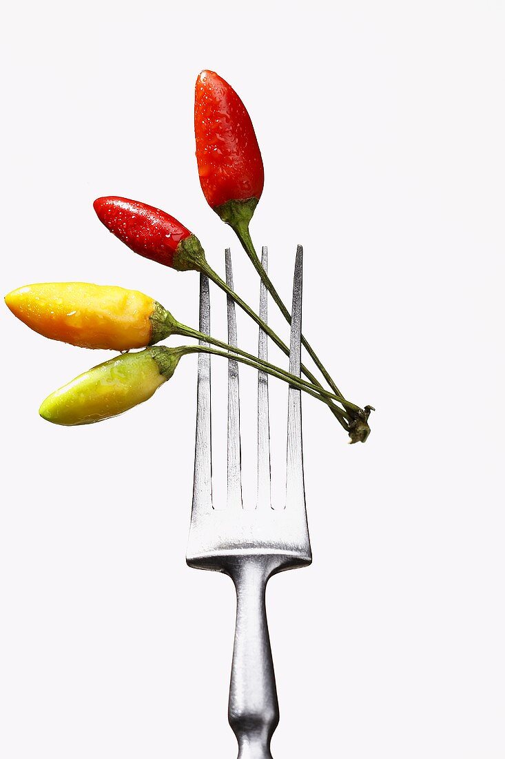 Four chili peppers on a fork