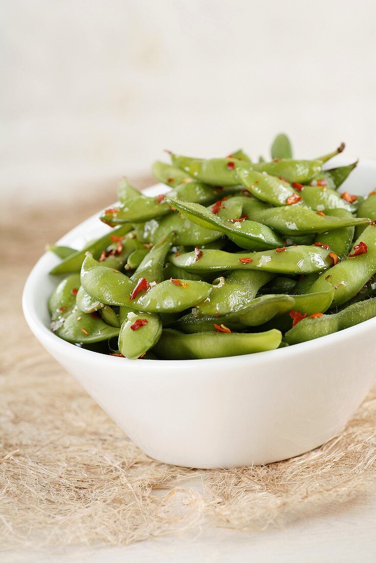 Cooked soya bean pods in bowl