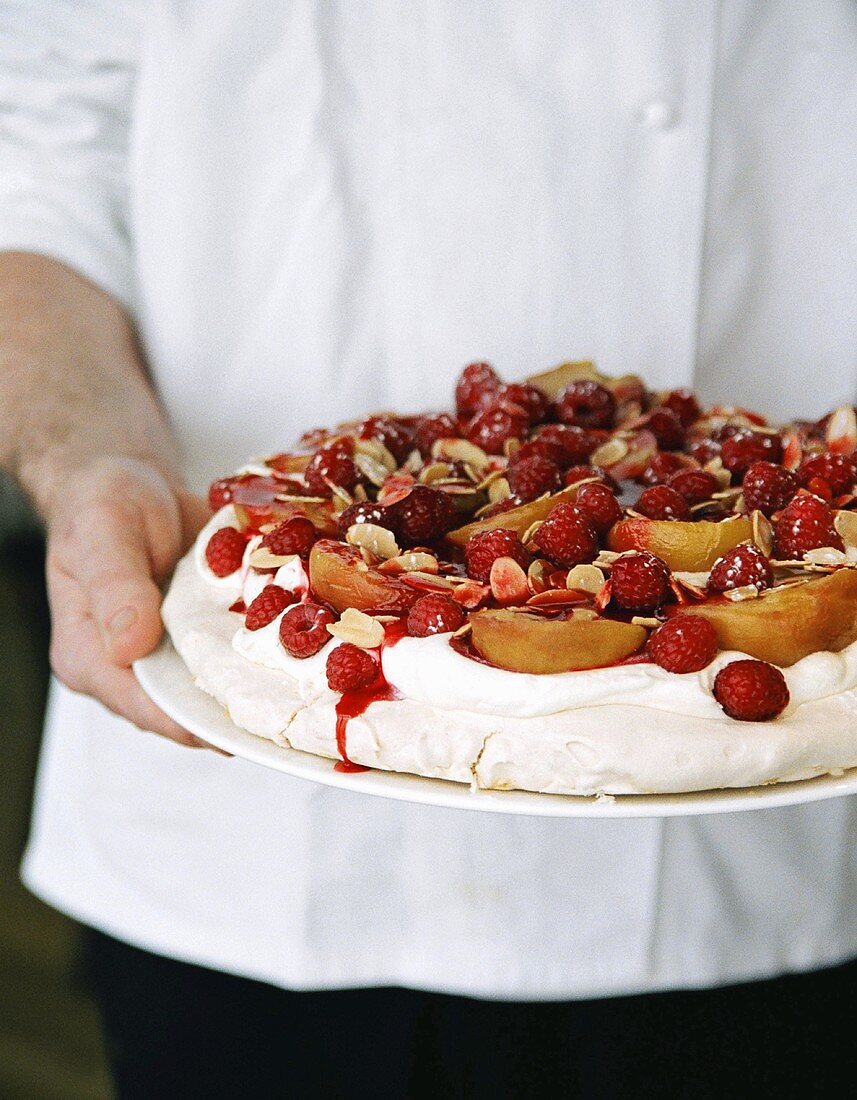 Pavlova with peaches and raspberries