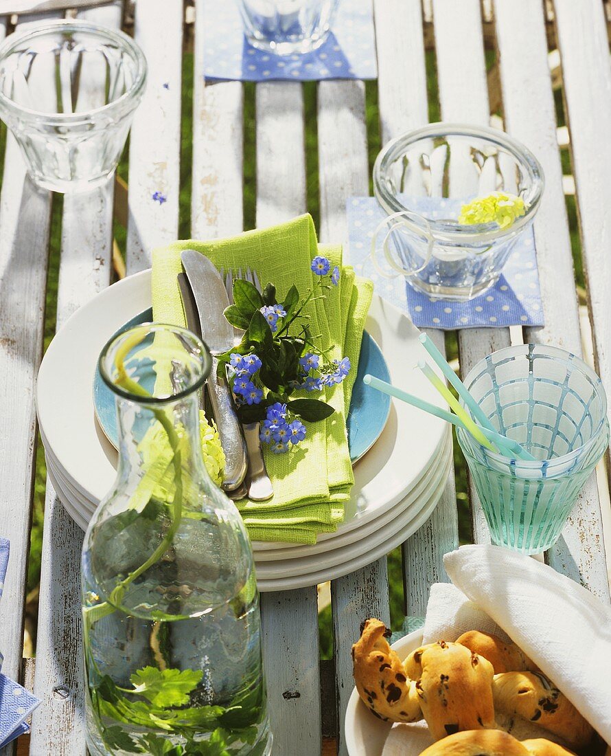 Table with plates and glasses in garden
