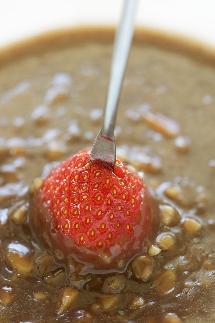 Dipping strawberries in chocolate fondue