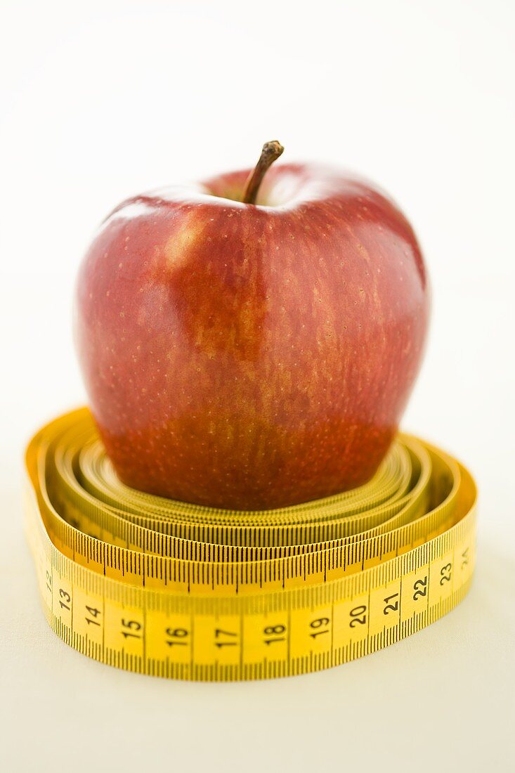 A tape measure around an apple