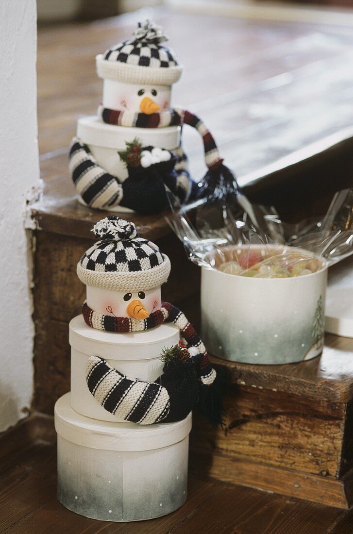 Two snowmen made from gift boxes with sweets