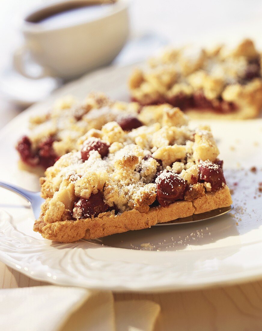 Three pieces of cherry crumble cake with marzipan