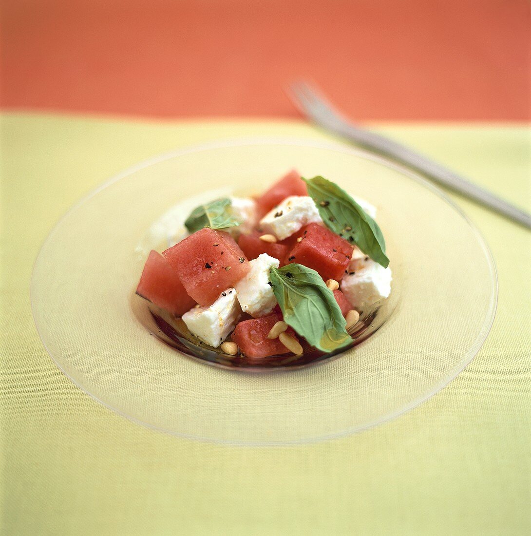 Pieces of watermelon with sheep's cheese and pine nuts