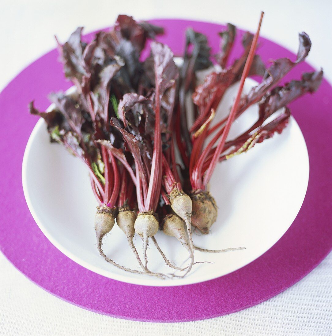 Small beetroots with leaves on a plate
