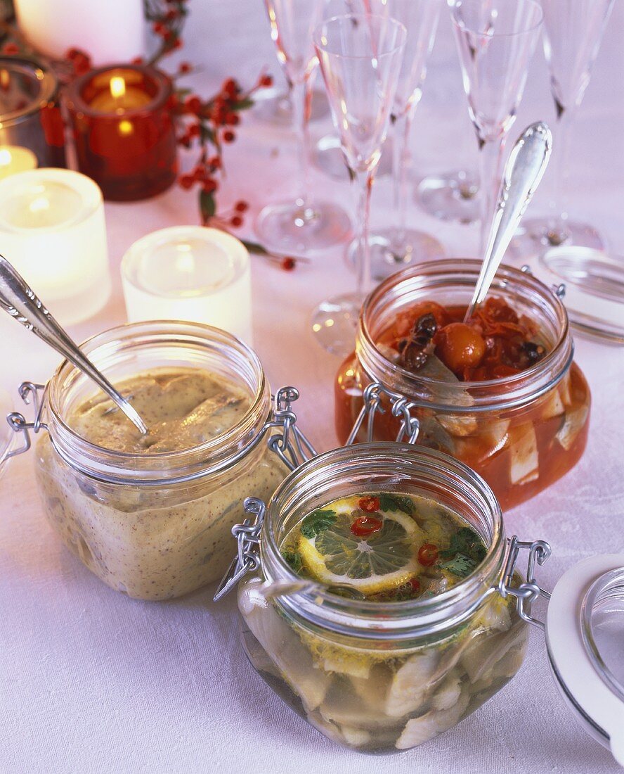Various types of pickled herrings in jars