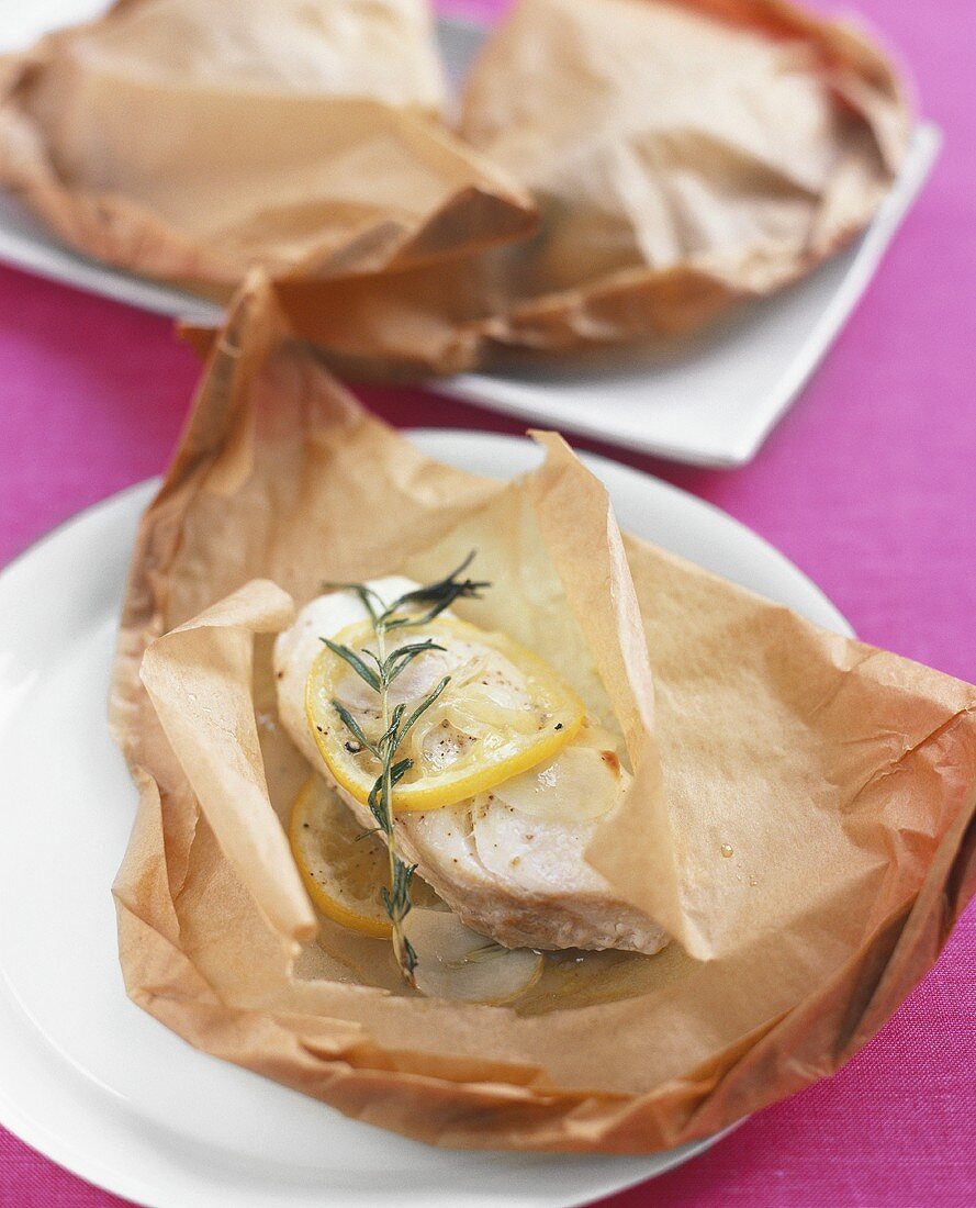 Fish fillet baked in baking parchment with rosemary & lemon