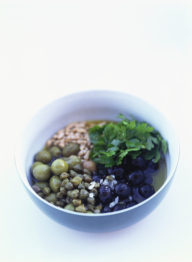 Ingredients for tapenade in a small bowl