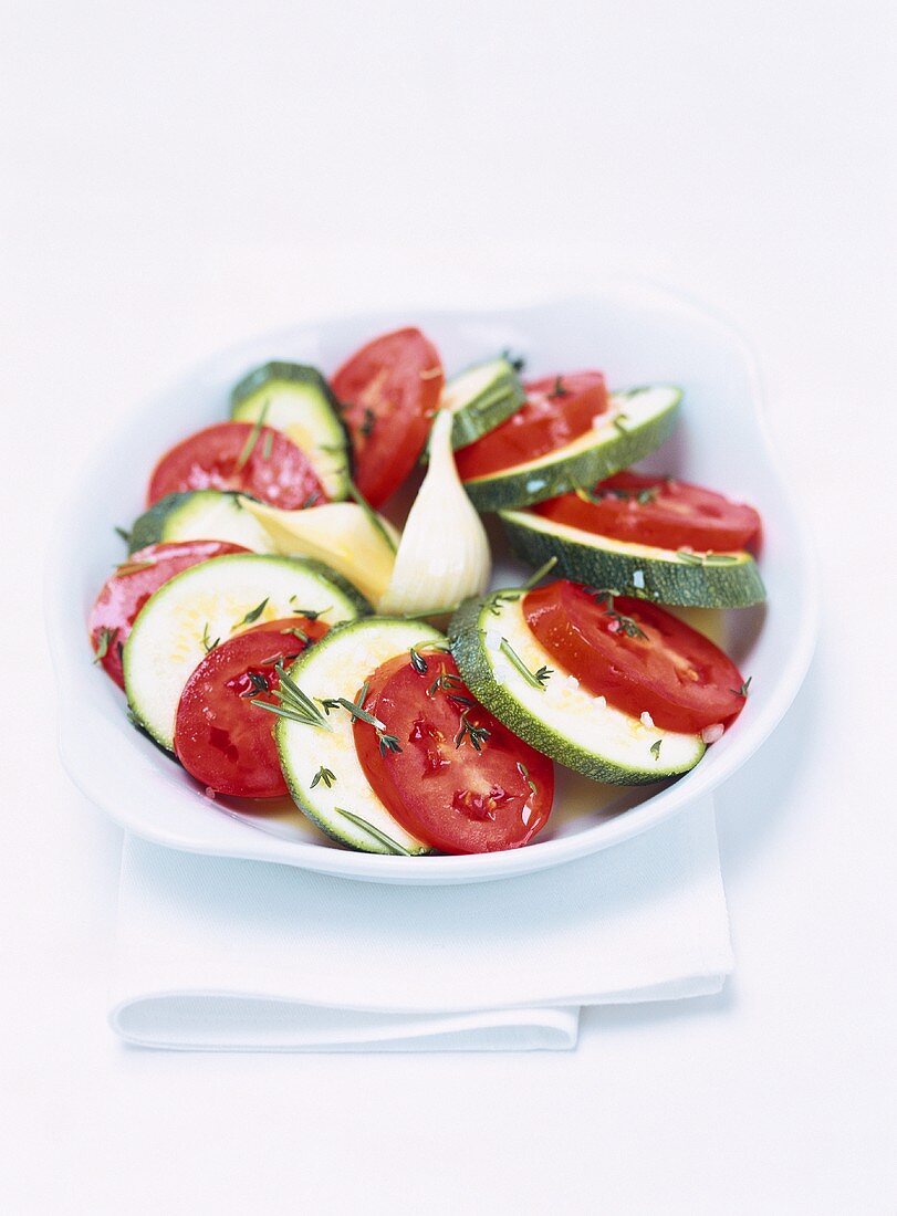 Tomatoes and courgettes sprinkled with herbs