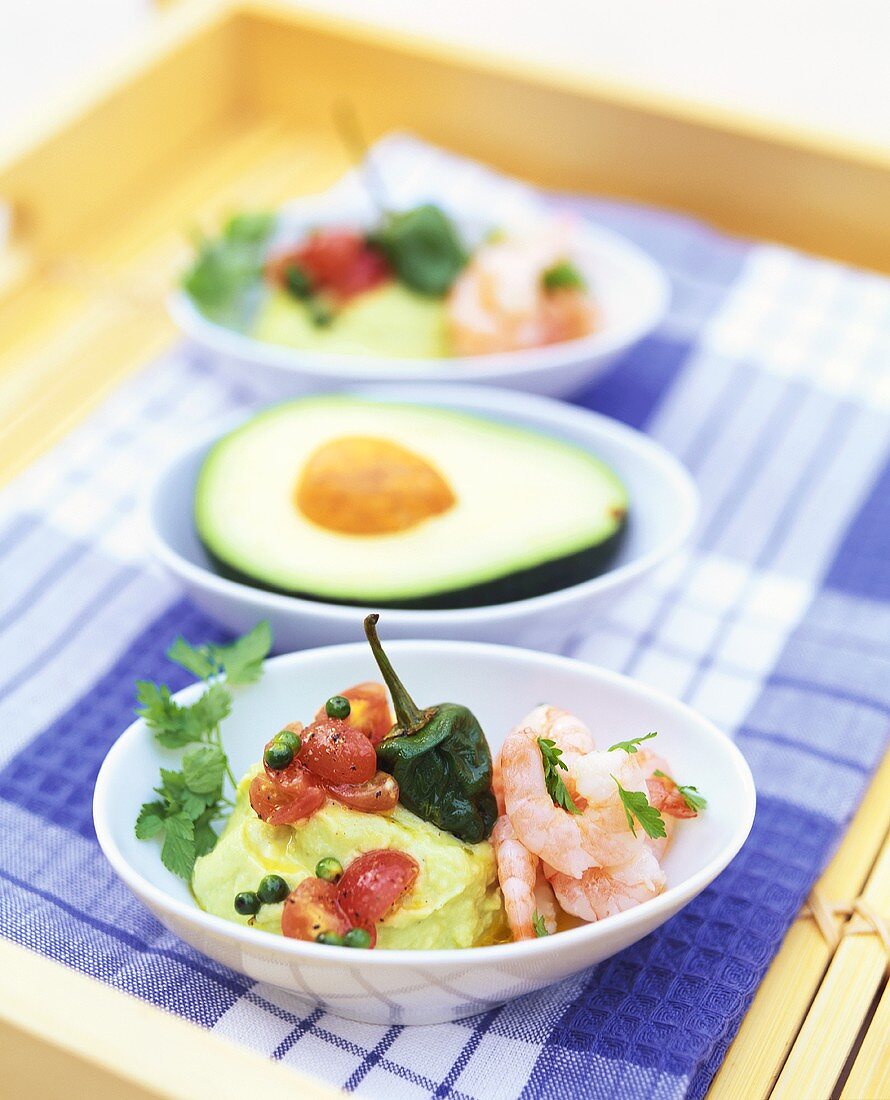 Avocado puree with tomatoes, shrimps and coriander