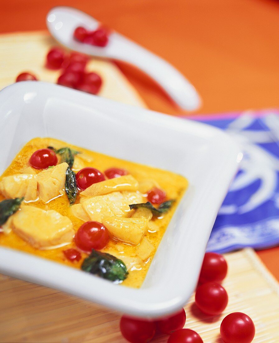 Yellow cod curry with pineapple and cherry tomatoes