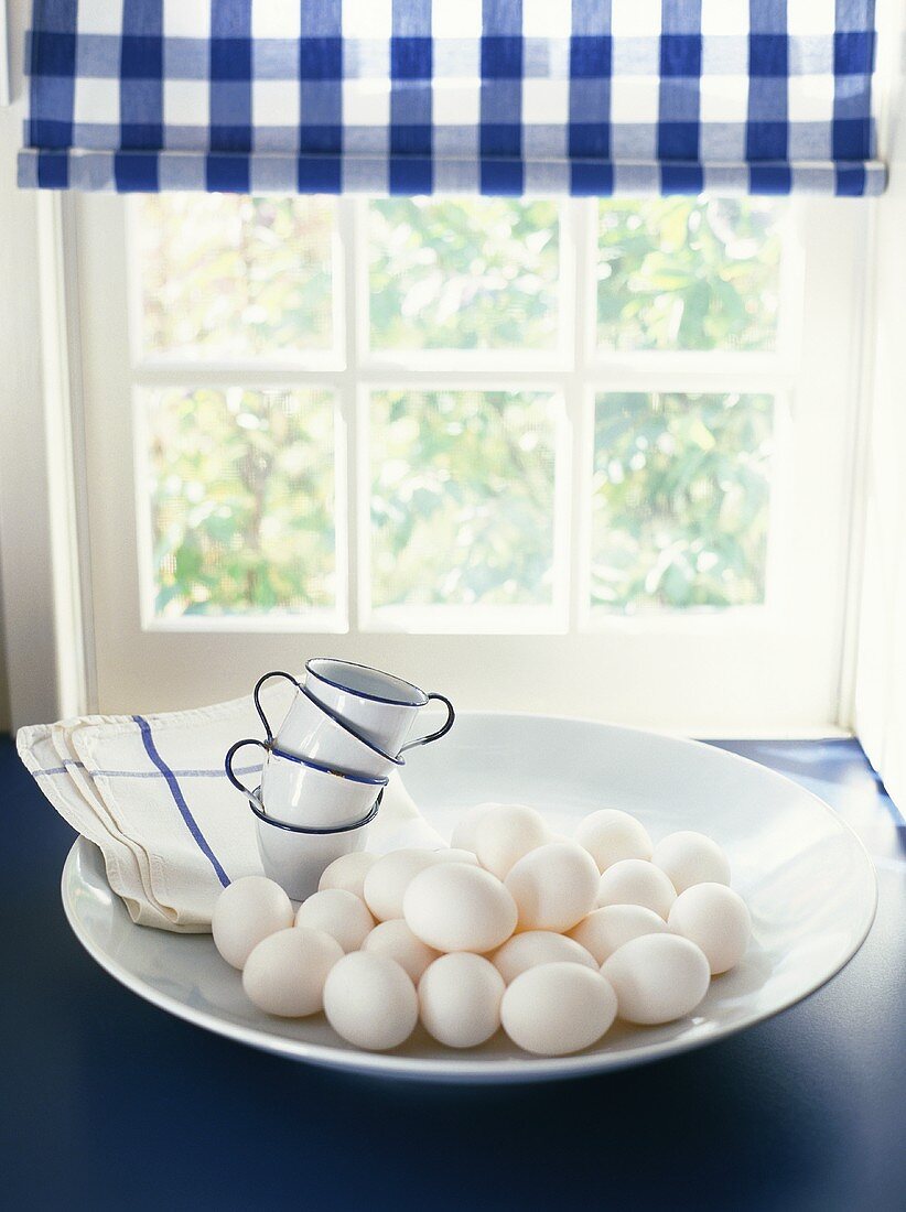 Fresh eggs in a dish by a window