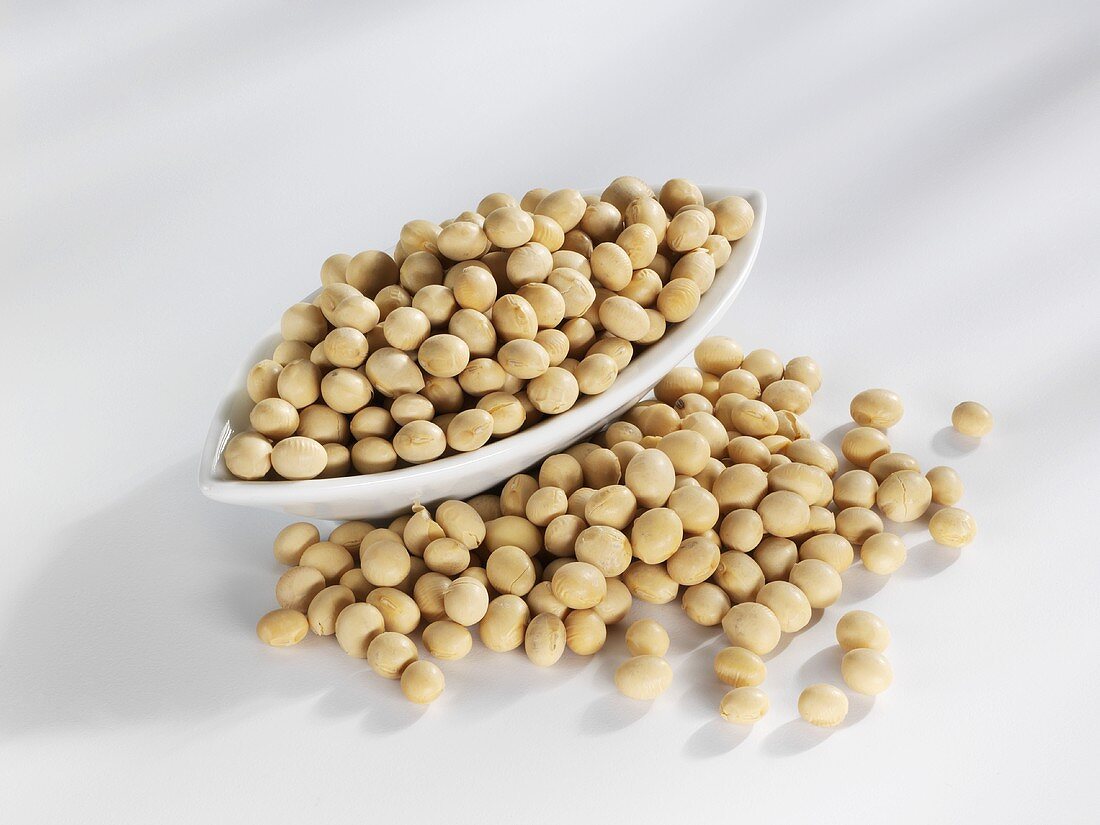 Soya beans in and in front of a bowl