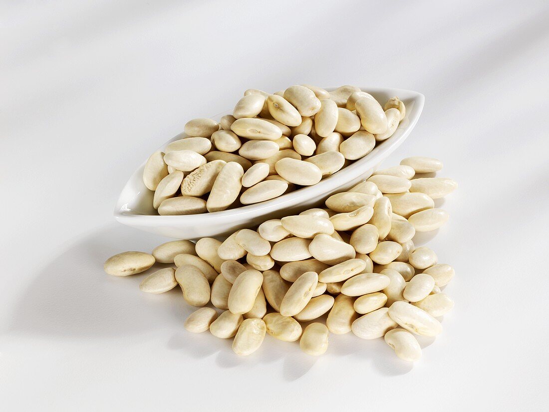 White beans in and in front of a bowl