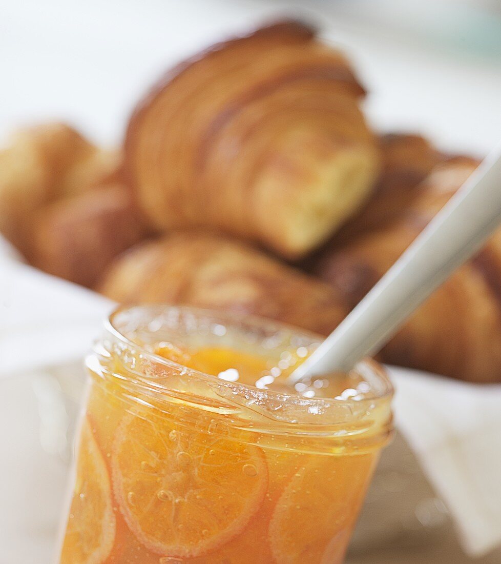 Mandarin orange jam in jar and croissants