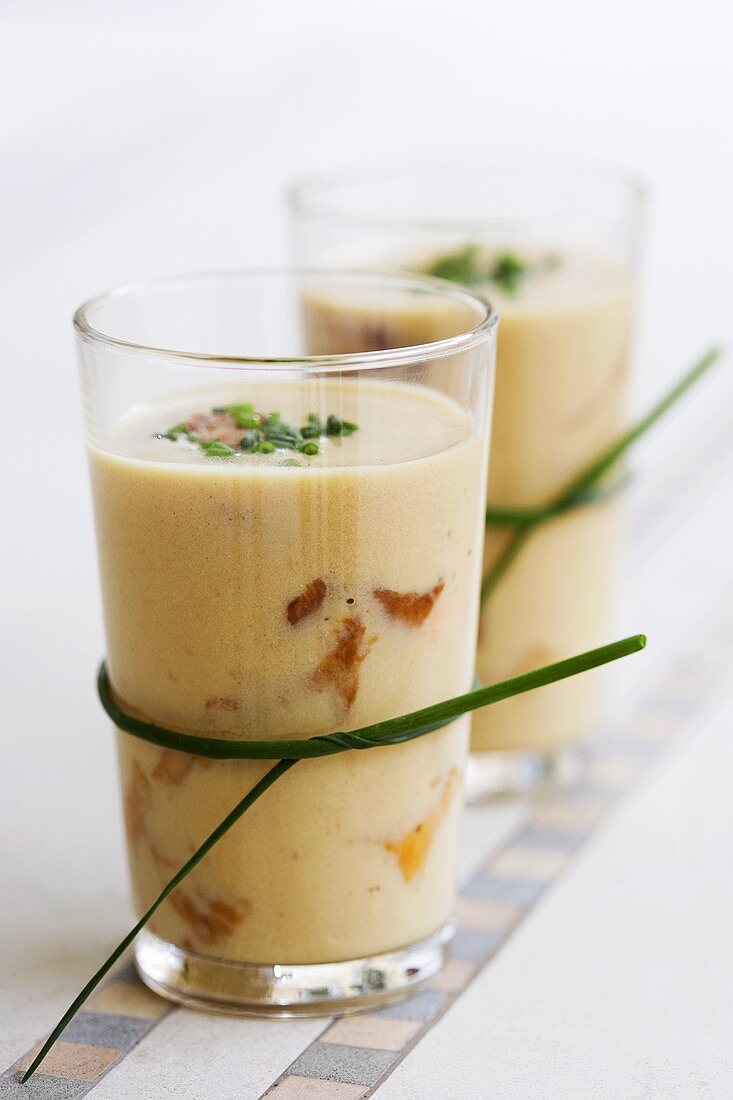 Mushroom soup with chives in glasses