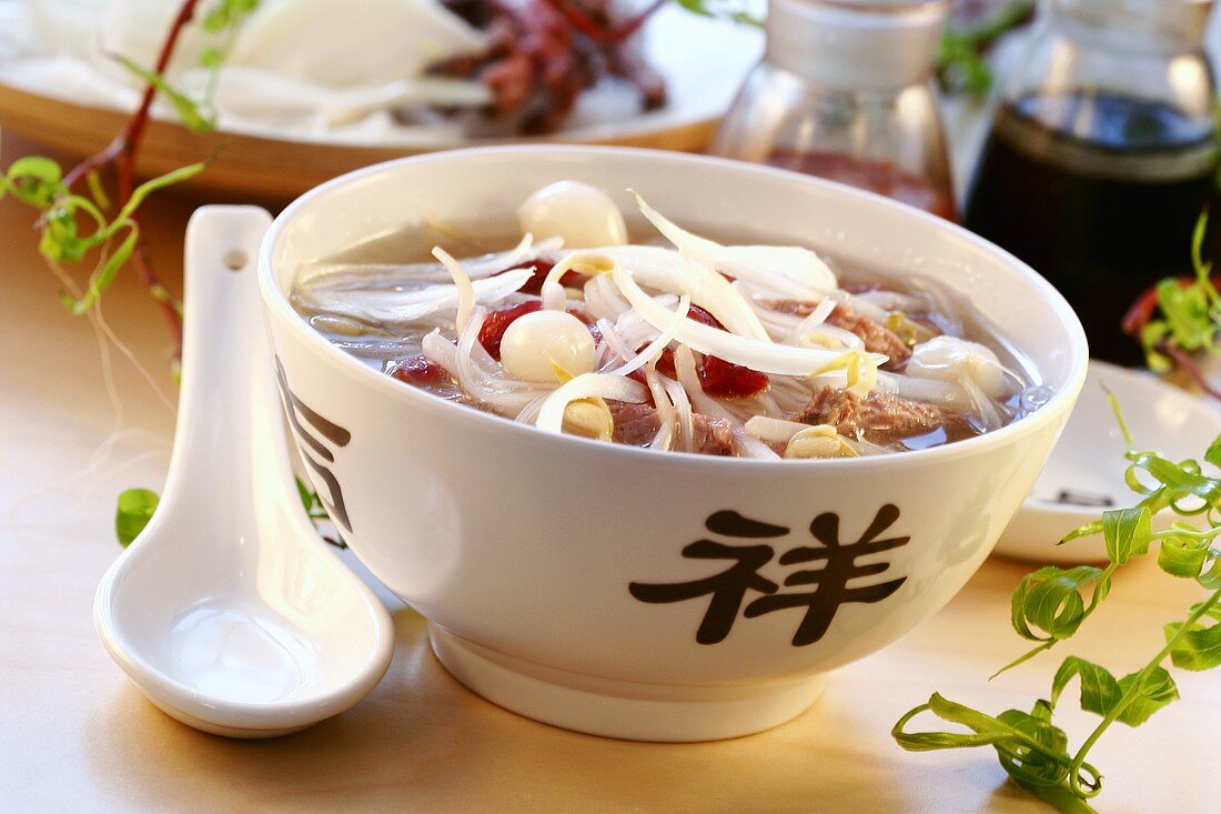 Broth with glass noodles, meat and vegetables