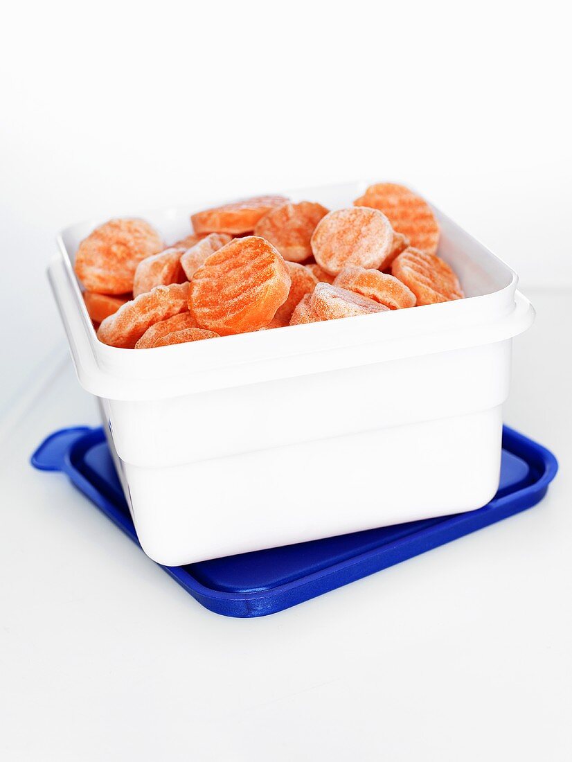 Frozen carrot slices in plastic box