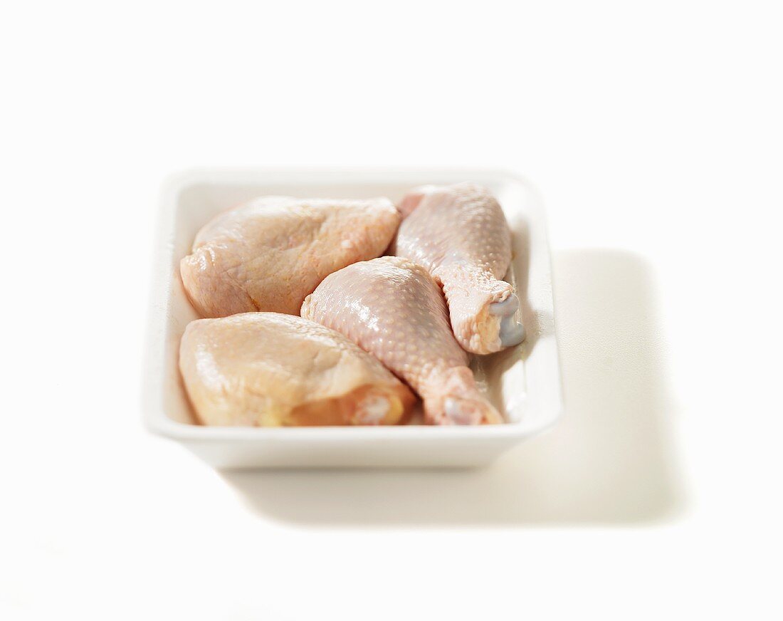 Chicken legs in a white dish