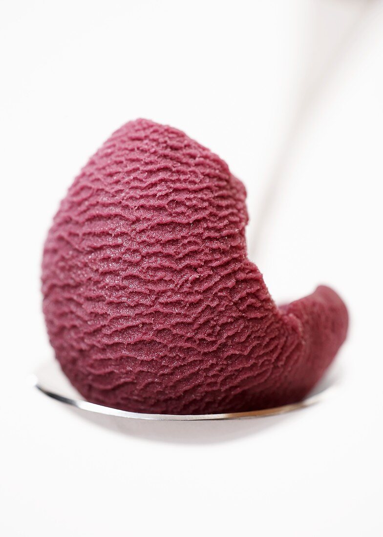 Fruits of the forest sorbet on a spoon