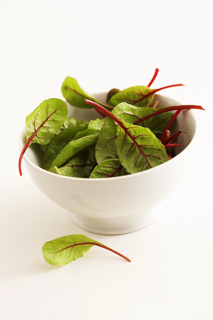 Young chard leaves in a small bowl