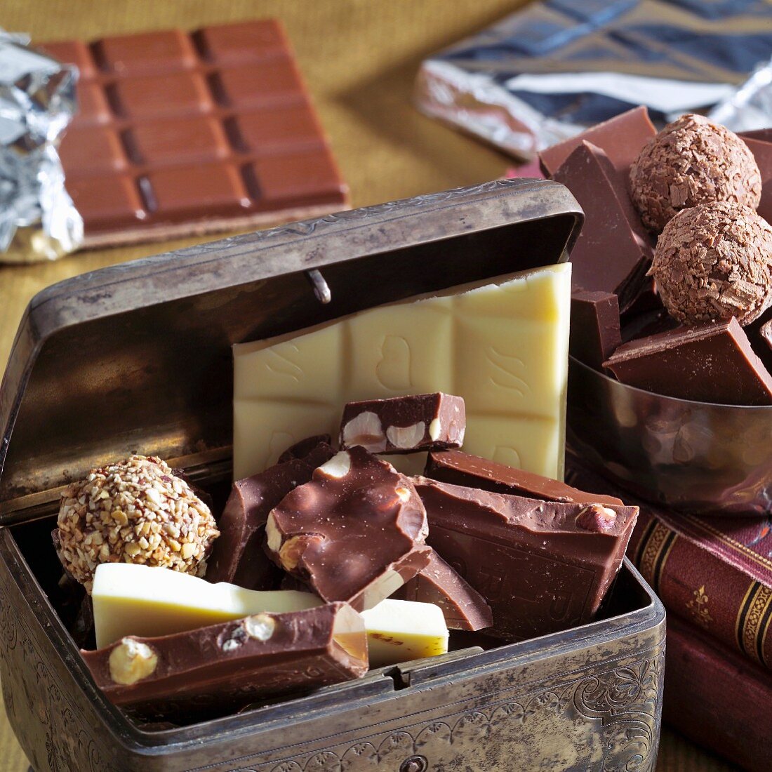 Pieces of chocolate and chocolates in a metal box