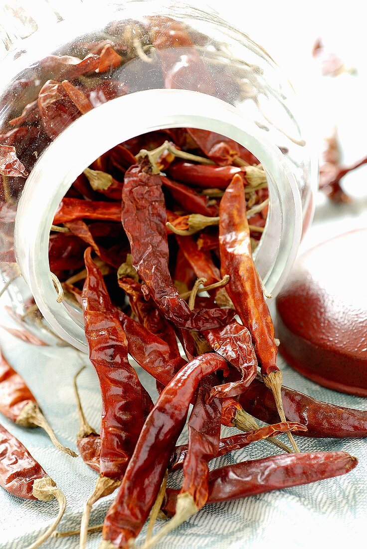 Chillies falling out of a jar