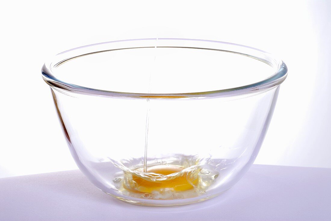 Breaking an egg into a bowl