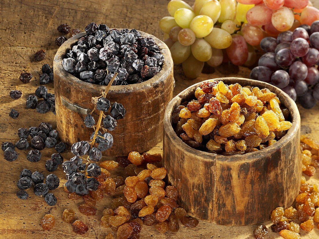 Raisins and currants in wooden bowls
