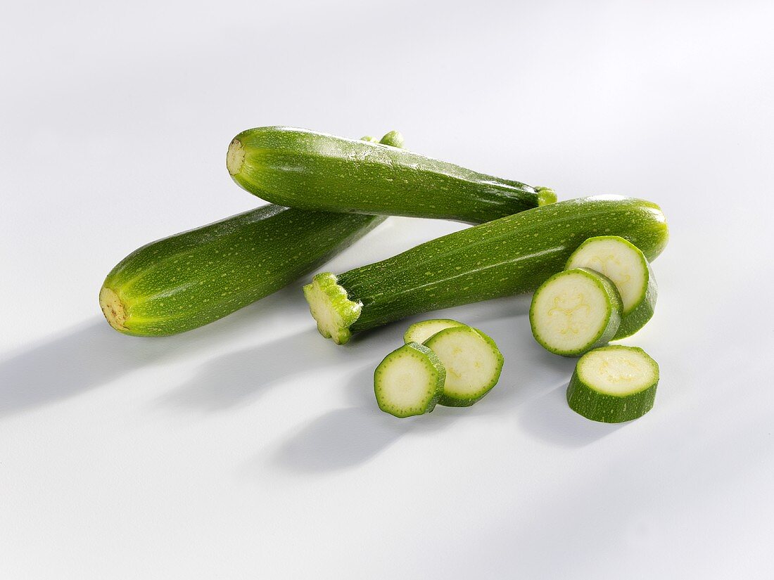 Three baby courgettes and courgette slices