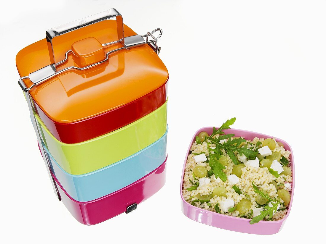 Lunch box and couscous salad with grapes and feta