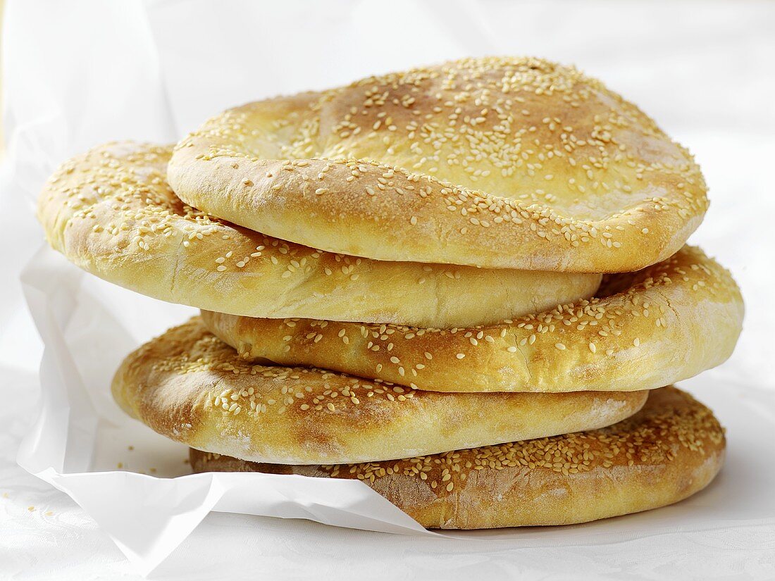 Five pita breads on greaseproof paper