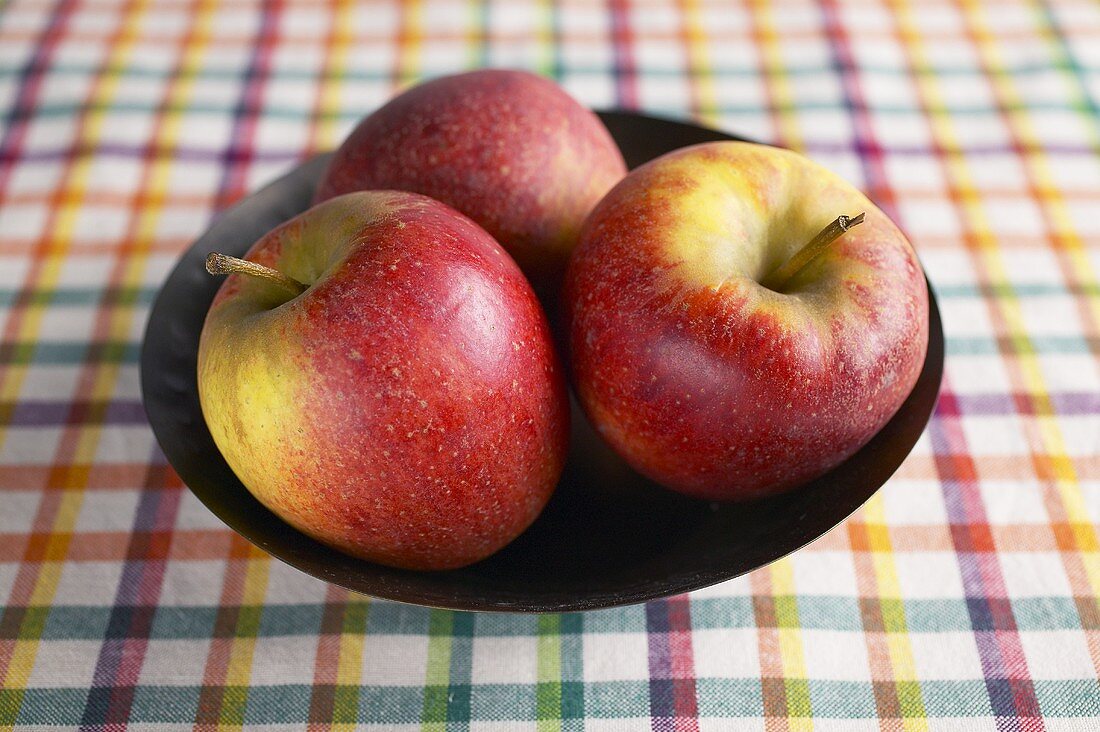 Three apples in a bowl