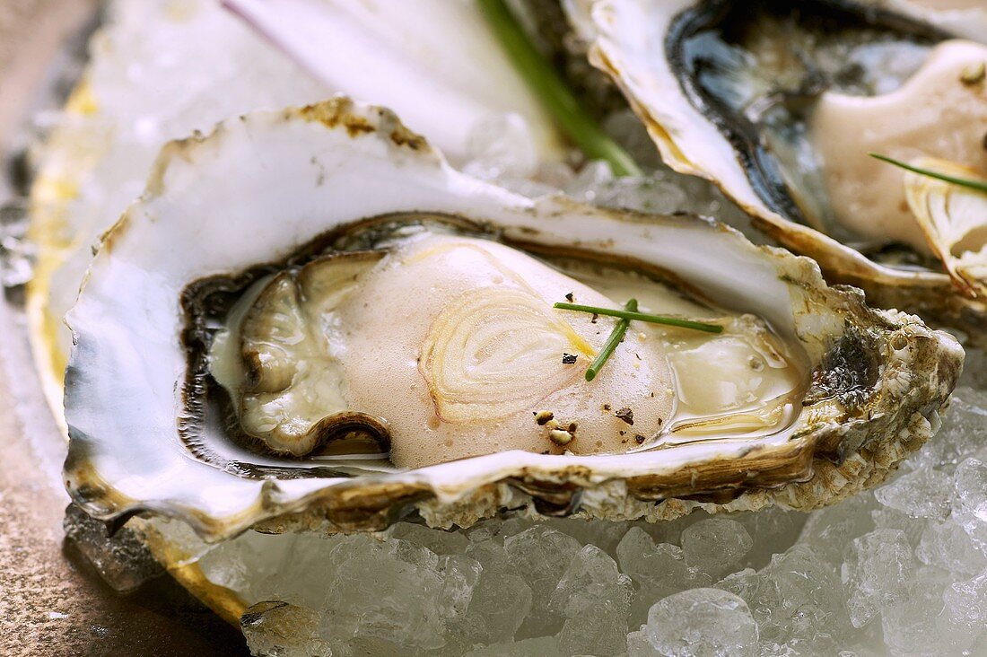 Two oysters with shallot and vinegar foam