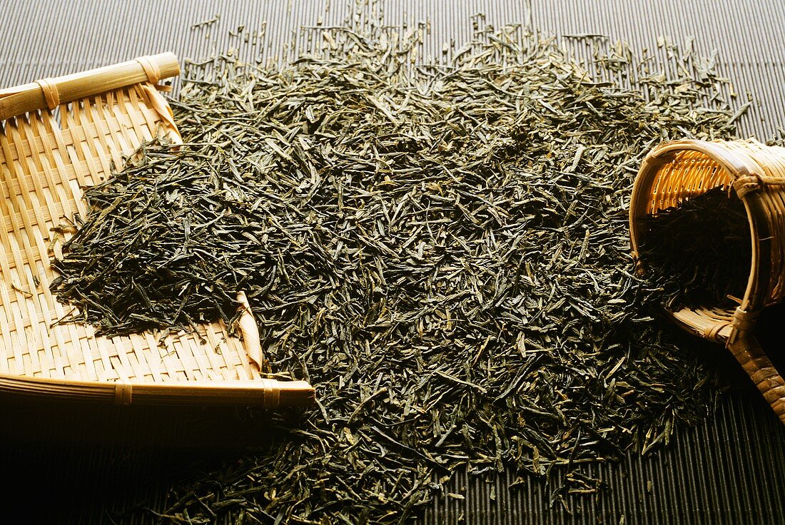 Green tea, dried leaves with bamboo tea strainer