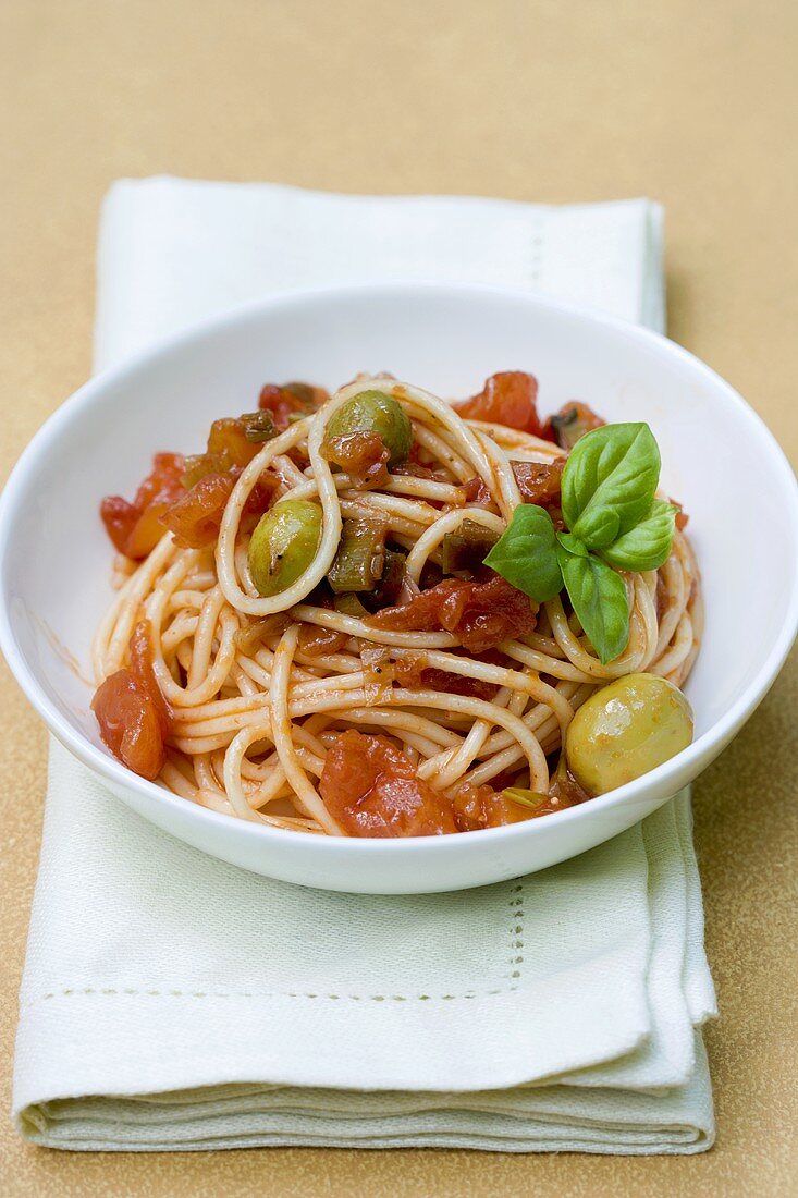 Spaghetti with tomato sauce and green olives