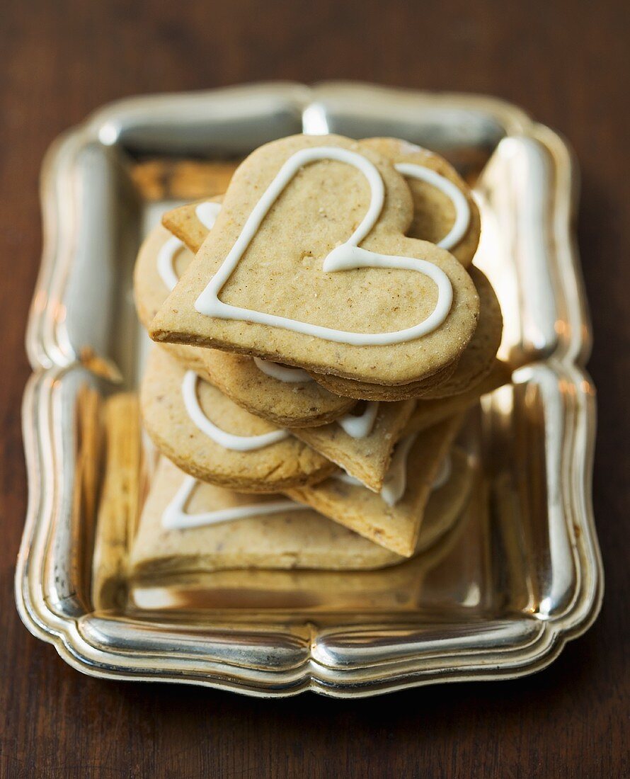 A pile of gingerbread hearts on a tray