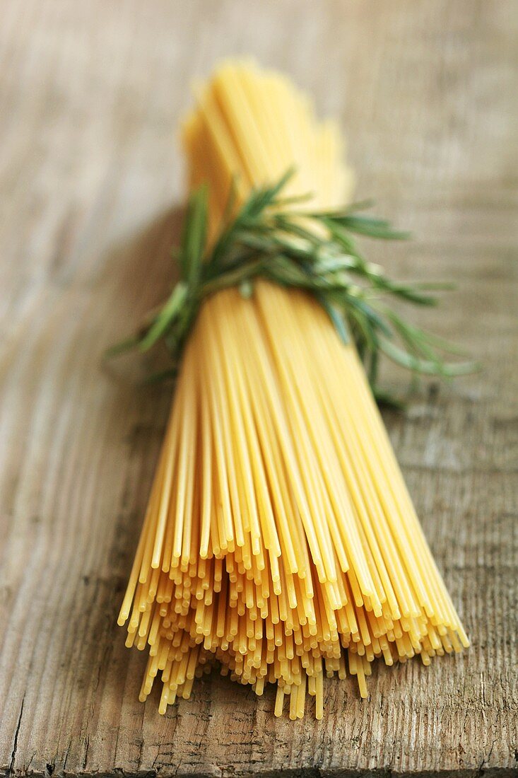 A bundle of spaghetti tied with rosemary
