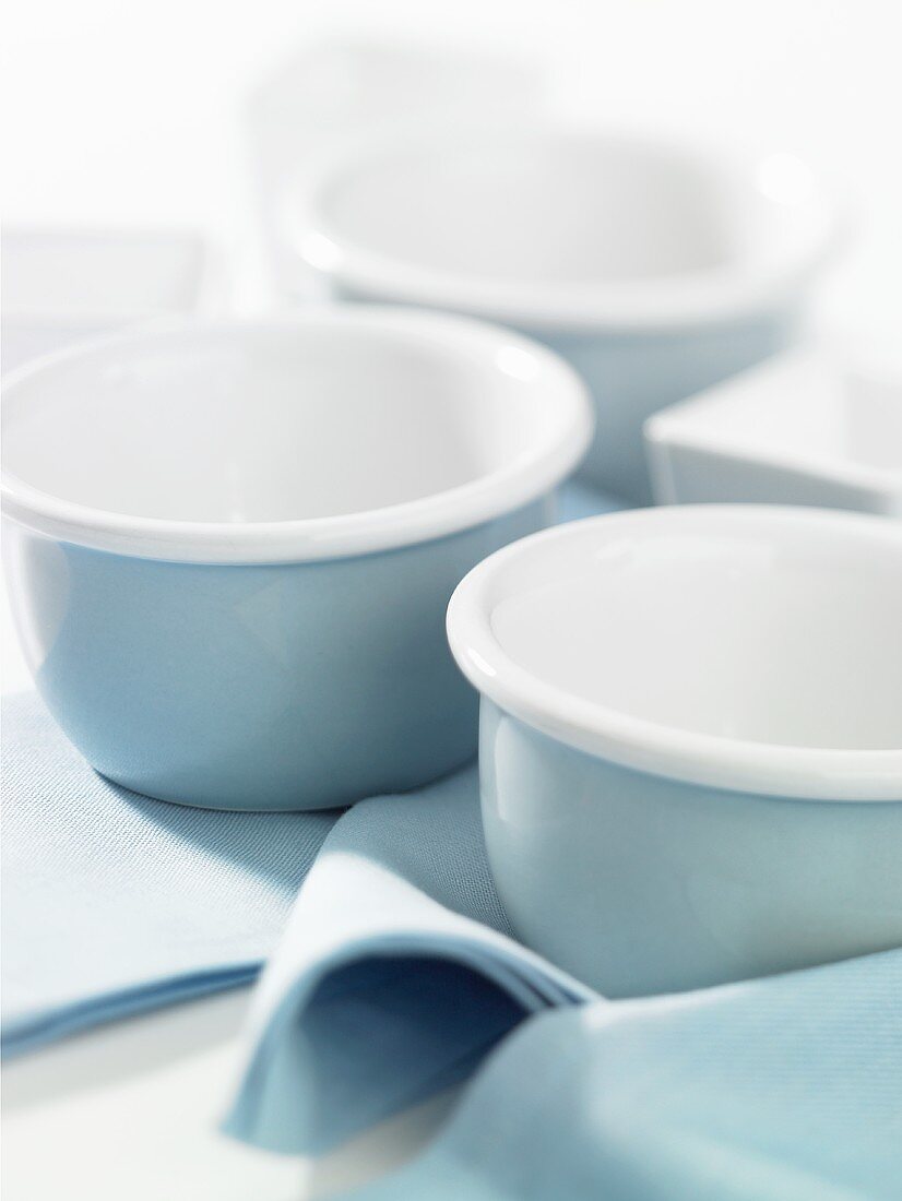 Three blue and white bowls on blue napkins