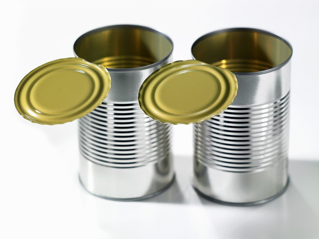 Two empty food tins with opened lids