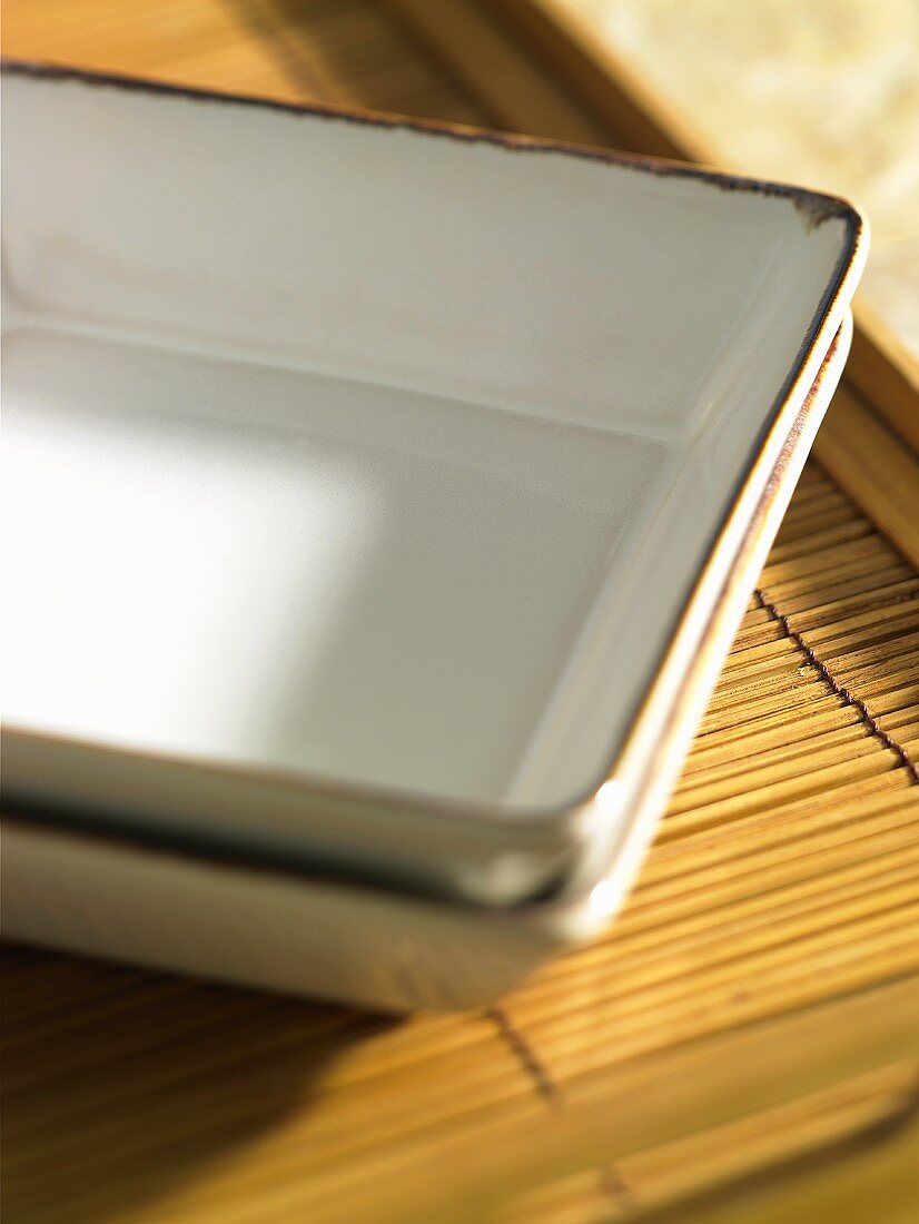 Two Asian bowls on a bamboo tray