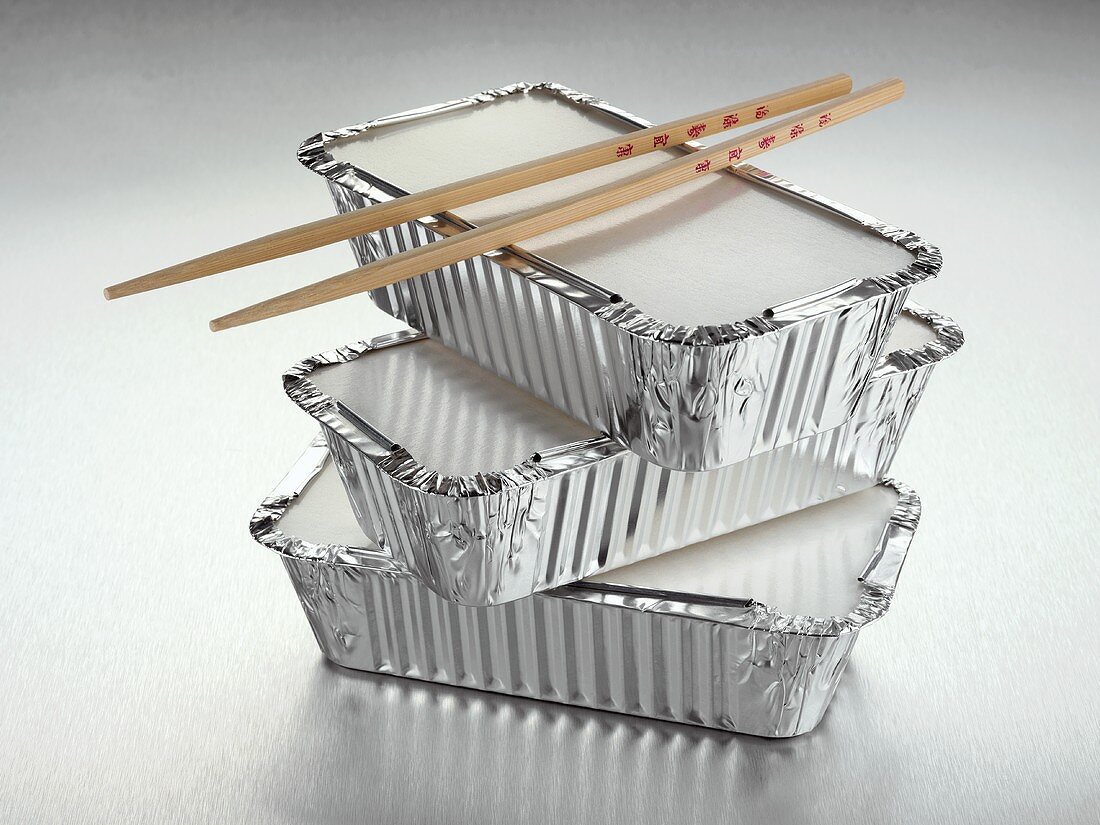 Three aluminium take-away food containers and chopsticks